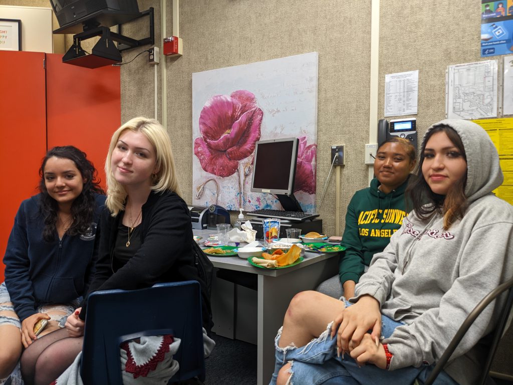 Happy students sitting at desk