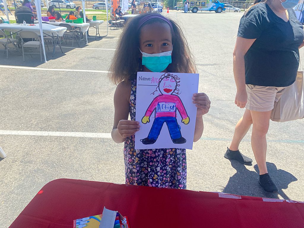 Young girl holding drawing
